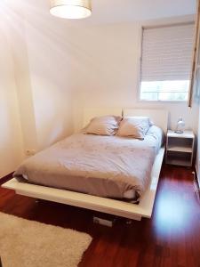 a bed in a small room with a window at Détente sur l huisne in Le Mans