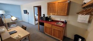 a kitchen with a sink and a microwave at Pictured Rocks Inn and Suites in Munising