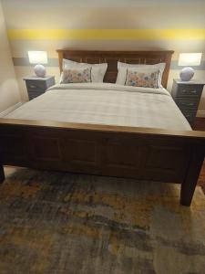 a large bed in a bedroom with two night stands at Ard Aoibhinn Roscommon in Lecarrow