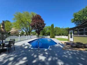 a swimming pool in a yard with a table and chairs at The Edamame House in Nazareth