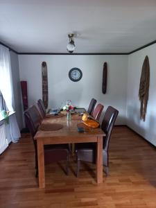 a dining room with a wooden table and chairs at Vakantiewoning in Småland Zuid-Zweden in Hjältevad