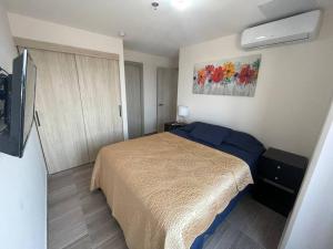 a bedroom with a bed and a television in it at Skyline Serenity: Luxury Retreat in Tegucigalpa in Tegucigalpa