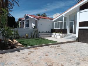 a house with a lawn in front of it at Cubanito 23 Vivienda de diseño junto al mar in Cartagena