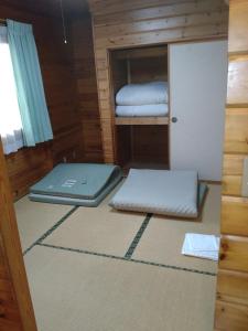a room with two bunk beds and a laptop at Hot Spring Resort Usui Pass Forest Park "Natural H - Vacation STAY 60418v in Karuizawa