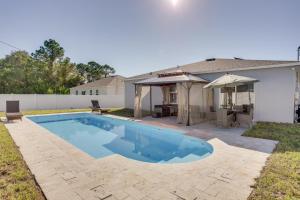 a swimming pool in the backyard of a house at 6 Mi to River Park Marina, Boardwalk Home with Pool in Port Saint Lucie