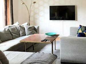 uma sala de estar com um sofá e uma mesa de centro em Holiday home Halmstad XII em Halmstad