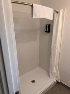 a shower with a shower curtain in a bathroom at The Lodge Tulelake in Tulelake