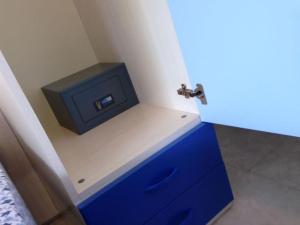 een badkamer met een blauwe dressoir en een tv bij Enjoy poolside comfort - Beahost Rentals in Bibione