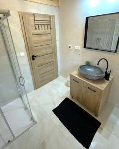 a bathroom with a sink and a shower at Chata Starý Mlyn in Habovka