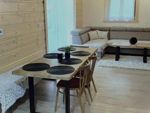 a living room with a table with chairs and a couch at Chata Starý Mlyn in Habovka