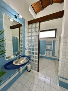 a bathroom with a sink and a mirror at Enchantment in the Heart of Nature in Canicattini Bagni