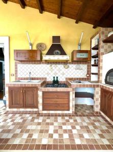 a kitchen with a sink and a stove at Enchantment in the Heart of Nature in Canicattini Bagni