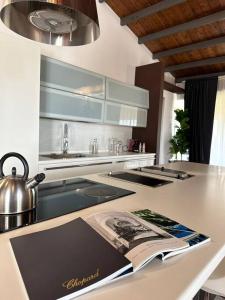 a kitchen with a counter with a book on it at Enchantment in the Heart of Nature in Canicattini Bagni