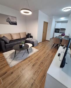 a living room with a couch and a table at Apartman WIN Sokobanja in Soko Banja +8 photos