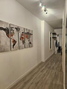 a room with four paintings on a wall at Sea View over Valletta Harbour 3 bedrooms 2 S4 in Sliema +37 photos
