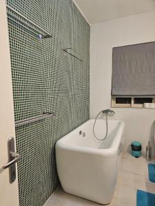 a bathroom with a white sink and a shower at Sea View over Valletta Harbour 3 bedrooms 2 S4 in Sliema