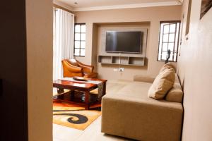 a living room with a couch and a tv at Toriso Hotels Group in Nelspruit