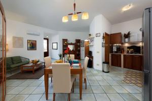 una cucina e un soggiorno con tavolo e sedie di Virgilio House a San Vito lo Capo Altre 15 foto