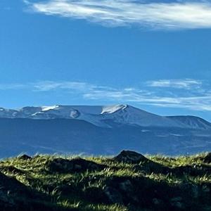 a mountain in the distance with snow on it at Beautiful Modern Shipping Container Cabin with Beautiful Views-Off the Grid in Waimea