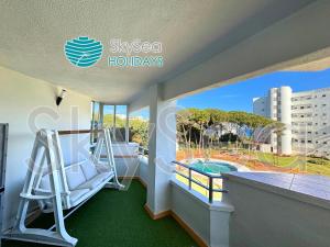 a balcony with a slide and a swimming pool at Sky Sea Holidays Calahonda LA ALGAIDA in Sitio de Calahonda