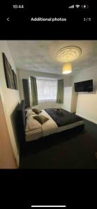 a bedroom with a large bed in a room at Luxury king en-suite room in Peterborough