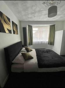 a bedroom with a bed and a window at Luxury king en-suite room in Peterborough