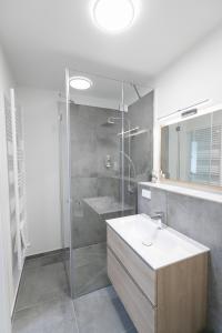 a bathroom with a shower and a sink and a shower at Helios Berlin Apartments in Berlin +92 photos