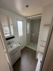 bagno bianco con lavandino e doccia di camping 4 Etoiles A ST JEANS-DE-MONTS Mobil home 4à6 pers a Saint-Jean-de-Monts
