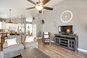 a living room with a couch and a tv at Stunning Oro Valley Home Near Catalina State Park in Oro Valley