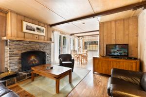 a living room with a couch and a fireplace at Elkhorn Lodge in Banff