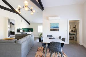 a living room with a couch and a table at Havelock Homestead in Havelock North