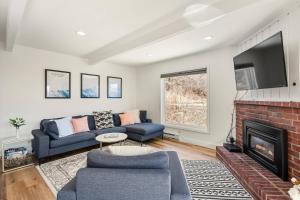 a living room with a couch and a fireplace at Woodbridge 34 C in Snowmass Village