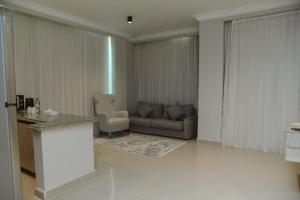 a living room with a couch and a chair at TK Royal & Spa in Hurghada