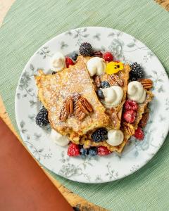 a plate of pancakes with fruit and nuts at The Citizen Hotel, Autograph Collection in Sacramento
