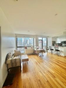 a living room with a couch and a table at Delancey Tower in Jersey City