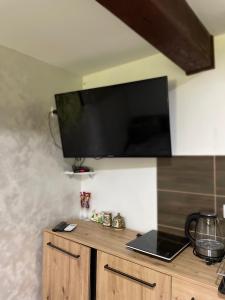 a flat screen tv on a wall with a laptop at Rooms P&L in Plav +17 photos