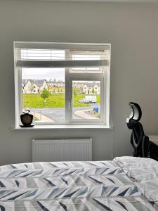 a bedroom with a window with a view of a yard at Room in Limerick in Limerick