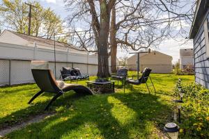 a yard with chairs and a tree and a swing at Elegant Serene Escape in Wyandotte 