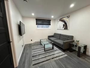 a living room with a couch and a table at Luxurya in Drummondville