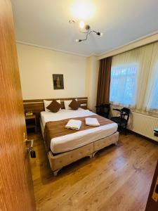 a bedroom with a large bed in a room at Aycan Sultan Apart Hotel in Istanbul