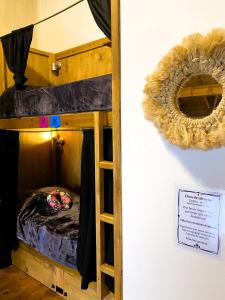 a room with bunk beds and a sign on a wall at Hostel Cosmo in El Bolsón