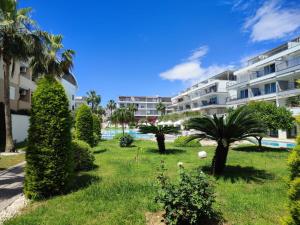 a resort yard with palm trees and a building at Manavgat - Superb 2 bedroom apartment near beach and Side centre in Side