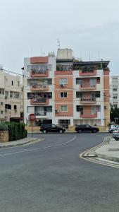 a stop sign in front of a large building at City Center Apartment 2 in Nicosia