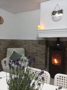 a dining room with a table and chairs and a fireplace at El Salero in Villargordo del Cabriel