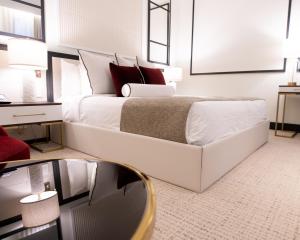 a bedroom with a large white bed with red pillows at Dylan Hotel NYC in New York