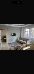 a living room with a large bed and a couch at MFC konaklama in Yeşilyurt