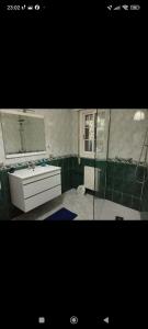 a bathroom with a white sink and a mirror at Apartamento Tui, Casa da Barca in Tui