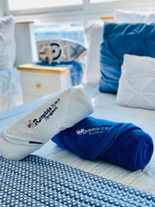 un par de calcetines sentados en la parte superior de una cama en Exclusivo, Moderno y Cómodo Apto temático con hermosa Vista al Mar en Playa Blanca