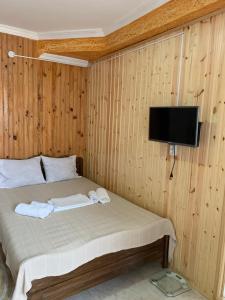 a bedroom with a bed with a tv on the wall at UREKI MARI MARI in Ureki +48 photos