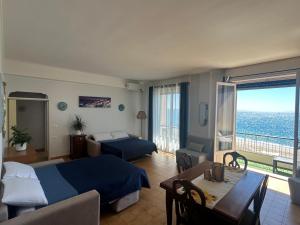 a hotel room with a bedroom with a bed and a table at VISTA MARE SAVONA in Savona